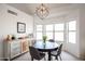 Cozy dining room with a modern chandelier, a sideboard and ample natural light at 4423 W Escuda Dr, Glendale, AZ 85308