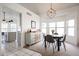 Cozy dining room with a modern chandelier, a sideboard and ample natural light at 4423 W Escuda Dr, Glendale, AZ 85308