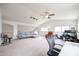 Spacious living room with high ceilings, featuring a cozy couch and dedicated desk space at 4423 W Escuda Dr, Glendale, AZ 85308