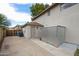 Side yard with access door, storage shed, and concrete pad, offering ample space for utilities and storage at 4423 W Escuda Dr, Glendale, AZ 85308