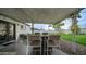 Back patio area featuring an outdoor dining set under a covered roof and view of the green backyard at 4630 N 12Th Pl, Phoenix, AZ 85014