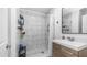 Bathroom features a modern vanity with sleek white countertop and a shower with large, bright marble-style tiling at 4630 N 12Th Pl, Phoenix, AZ 85014