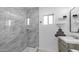 Modern bathroom featuring a glass-enclosed shower, marble-look tile, and contemporary fixtures at 4630 N 12Th Pl, Phoenix, AZ 85014