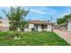 Charming home with a well-manicured lawn, a decorative front tree, and an inviting blue door for stylish curb appeal at 4630 N 12Th Pl, Phoenix, AZ 85014