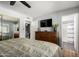 Bedroom boasts a modern TV, dresser, and mirrored closet, offering functionality and style at 4810 W Kelton Ln, Glendale, AZ 85306