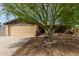 Charming home featuring a low-maintenance landscaped yard and a large shade tree at 4810 W Kelton Ln, Glendale, AZ 85306