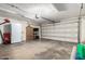 Spacious garage with ample storage and a large garage door, perfect for vehicles and projects at 4810 W Kelton Ln, Glendale, AZ 85306