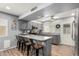 The kitchen boasts gray cabinets, a stainless steel dishwasher, and wood-look flooring at 4810 W Kelton Ln, Glendale, AZ 85306