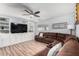 Spacious living room featuring a TV, sofa, and built-in shelving at 4810 W Kelton Ln, Glendale, AZ 85306