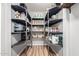 The walk-in pantry features shelving for optimal storage and organization at 4810 W Kelton Ln, Glendale, AZ 85306