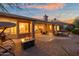 Expansive backyard featuring a built-in grill, covered patio with seating, and fire pit, ideal for entertaining at 6339 S Palo Blanco Dr, Gold Canyon, AZ 85118