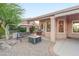 Beautiful backyard featuring an outdoor swing, fire pit, grill and well-maintained landscaping at 6339 S Palo Blanco Dr, Gold Canyon, AZ 85118