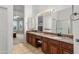 Bathroom featuring double sinks, granite counters, ample vanity storage and tile flooring at 6339 S Palo Blanco Dr, Gold Canyon, AZ 85118