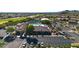 Aerial view of community clubhouse, pool, tennis courts, parking and manicured green space at 6339 S Palo Blanco Dr, Gold Canyon, AZ 85118