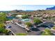 Overhead view of a community pool, tennis courts, and nearby golf course at 6339 S Palo Blanco Dr, Gold Canyon, AZ 85118