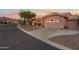 Charming single-story home with a well-manicured lawn, desert landscaping and a two-car garage at 6339 S Palo Blanco Dr, Gold Canyon, AZ 85118