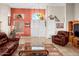 Bright living room with tile floors, front door access and comfortable leather seating at 6339 S Palo Blanco Dr, Gold Canyon, AZ 85118