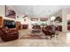 Comfortable living room featuring a fireplace, tile flooring, and large windows at 6339 S Palo Blanco Dr, Gold Canyon, AZ 85118