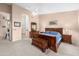 Bright main bedroom with wooden furniture, neutral walls, and an open doorway to the bathroom at 6339 S Palo Blanco Dr, Gold Canyon, AZ 85118