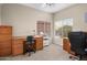 Home office featuring a desk, windows, and neutral-toned walls and carpeting at 6339 S Palo Blanco Dr, Gold Canyon, AZ 85118