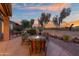 Inviting patio with a fire pit, seating area and views of the beautifully landscaped backyard and golf course at 6339 S Palo Blanco Dr, Gold Canyon, AZ 85118