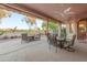 Covered patio with lots of seating, attractive landscaping and views of the nearby golf course at 6339 S Palo Blanco Dr, Gold Canyon, AZ 85118