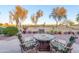 Patio with a cozy fire pit and comfortable seating overlooking the golf course at 6339 S Palo Blanco Dr, Gold Canyon, AZ 85118