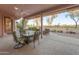 The covered patio boasts a ceiling fan and plenty of seating for entertaining with great views at 6339 S Palo Blanco Dr, Gold Canyon, AZ 85118