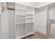 Walk-in closet with white shelving, wire baskets, and hanging rods at 6339 S Palo Blanco Dr, Gold Canyon, AZ 85118