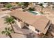 Backyard with a large pool, shaded structure, and gravel landscaping at 6428 E Shea Blvd, Scottsdale, AZ 85254