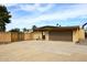 Side of house with garage, small trees, and desert landscaping at 6428 E Shea Blvd, Scottsdale, AZ 85254