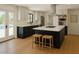 Bright kitchen features an island with bar seating, white cabinetry, and modern appliances at 6428 E Shea Blvd, Scottsdale, AZ 85254