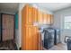 This laundry room boasts a full-sized washer and dryer and ample storage in the upper and lower cabinets at 6428 E Shea Blvd, Scottsdale, AZ 85254