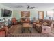 Cozy living room with leather sofas, a large rug, and a ceiling fan at 6428 E Shea Blvd, Scottsdale, AZ 85254