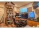 Office with multiple screens, wood flooring, and ceiling fan at 6428 E Shea Blvd, Scottsdale, AZ 85254
