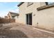 Backyard featuring a stone patio and sliding glass door, offering a private outdoor space at 7336 S 48Th Gln, Laveen, AZ 85339