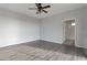 Well-lit bedroom with smooth flooring, a ceiling fan, and easy access to an adjacent bathroom at 7336 S 48Th Gln, Laveen, AZ 85339