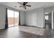 Spacious bedroom featuring sleek flooring, a ceiling fan, and a sliding glass door to the backyard at 7336 S 48Th Gln, Laveen, AZ 85339