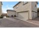Exterior view showcasing the attached garage, with an adjacent walkway and manicured bushes at 7336 S 48Th Gln, Laveen, AZ 85339