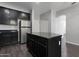 Stylish kitchen features stainless steel appliances, ample cabinet space, and an island with countertop at 7336 S 48Th Gln, Laveen, AZ 85339