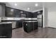 Modern kitchen boasts stainless steel appliances, dark countertops, and a functional center island at 7336 S 48Th Gln, Laveen, AZ 85339