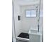 Bathroom featuring a sleek black and white tiled shower and a modern vanity with stylish fixtures at 7420 N 58Th Ave, Glendale, AZ 85301