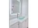 Bathroom vanity featuring vessel sink and lighted mirror at 7420 N 58Th Ave, Glendale, AZ 85301