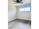 Bright bedroom featuring new flooring, neutral wall color, and an updated ceiling fan and light fixture at 7420 N 58Th Ave, Glendale, AZ 85301