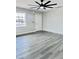 Open floorplan bedroom featuring wood-look floors and ceiling fan at 7420 N 58Th Ave, Glendale, AZ 85301