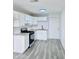 Bright kitchen featuring white cabinets, gray countertops, stainless steel appliances, and modern gray flooring at 7420 N 58Th Ave, Glendale, AZ 85301