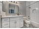 Clean bathroom featuring white cabinets, a white subway-tile shower, decorative tile floor, and quartz countertops at 815 E Rose Ln # 105, Phoenix, AZ 85014