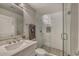 Bathroom featuring glass shower, stone flooring, modern vanity, and soft lighting at 815 E Rose Ln # 105, Phoenix, AZ 85014