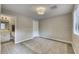 Neutral bedroom with wood-look tile, modern ceiling light, and an adjacent bathroom at 815 E Rose Ln # 105, Phoenix, AZ 85014