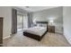 Spacious bedroom featuring carpet, neutral walls, a large window, and decorative lamps and nightstands at 815 E Rose Ln # 105, Phoenix, AZ 85014